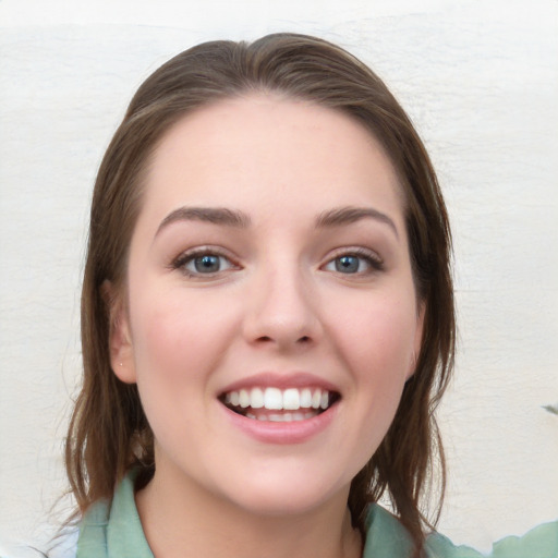 Joyful white young-adult female with medium  brown hair and blue eyes