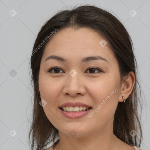 Joyful asian young-adult female with medium  brown hair and brown eyes