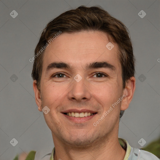 Joyful white adult male with short  brown hair and grey eyes