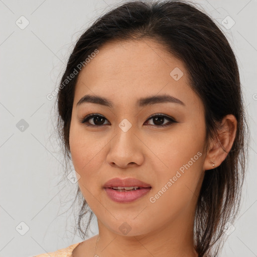 Joyful latino young-adult female with medium  brown hair and brown eyes