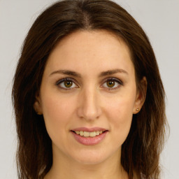 Joyful white young-adult female with long  brown hair and green eyes