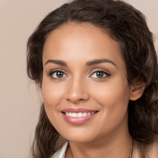 Joyful white young-adult female with long  brown hair and brown eyes