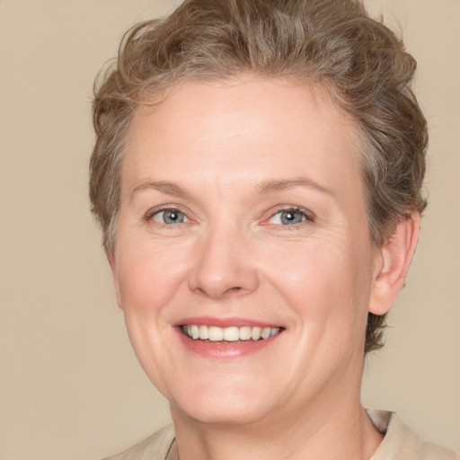 Joyful white adult female with short  brown hair and grey eyes