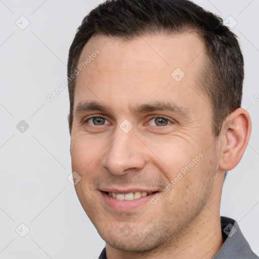 Joyful white adult male with short  brown hair and brown eyes