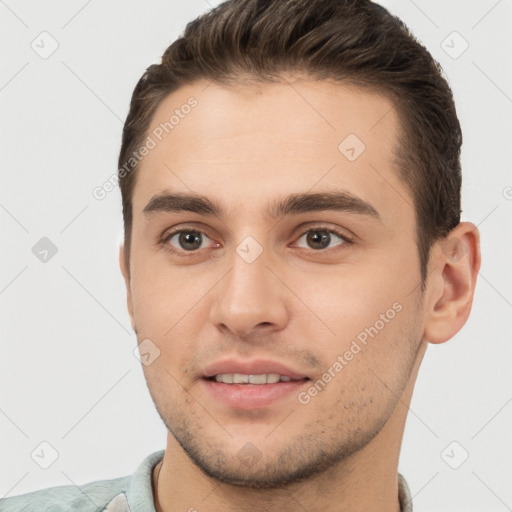 Joyful white young-adult male with short  brown hair and brown eyes