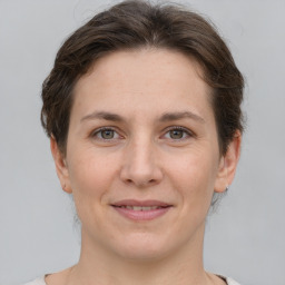 Joyful white adult female with short  brown hair and grey eyes