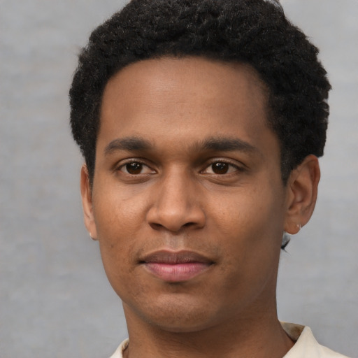 Joyful black young-adult male with short  black hair and brown eyes