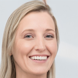 Joyful white young-adult female with long  brown hair and blue eyes