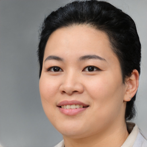 Joyful asian young-adult female with medium  black hair and brown eyes