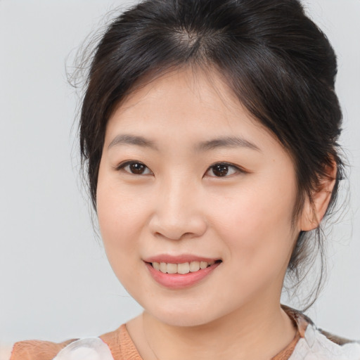 Joyful asian young-adult female with medium  brown hair and brown eyes