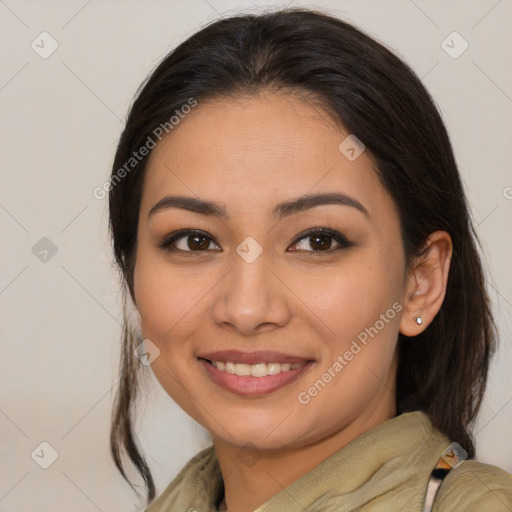 Joyful latino young-adult female with medium  brown hair and brown eyes