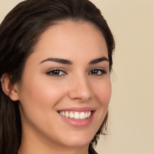 Joyful white young-adult female with long  brown hair and brown eyes