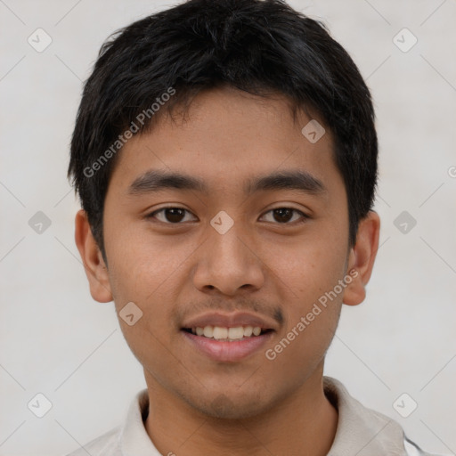 Joyful asian young-adult male with short  brown hair and brown eyes