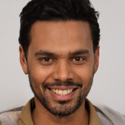 Joyful white young-adult male with short  black hair and brown eyes