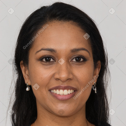 Joyful black young-adult female with long  brown hair and brown eyes