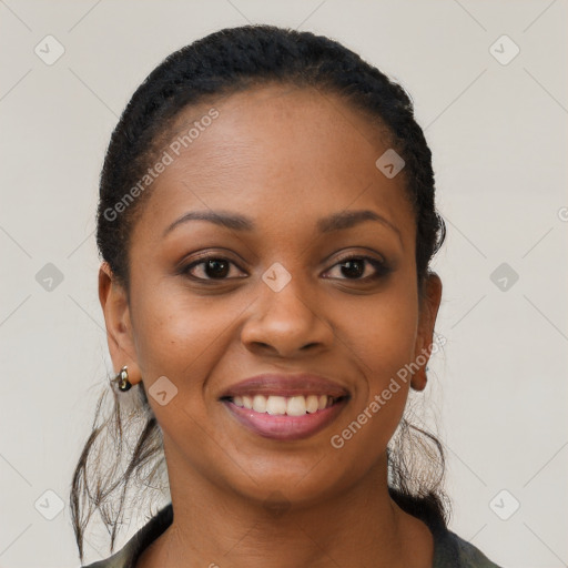 Joyful black young-adult female with short  black hair and brown eyes