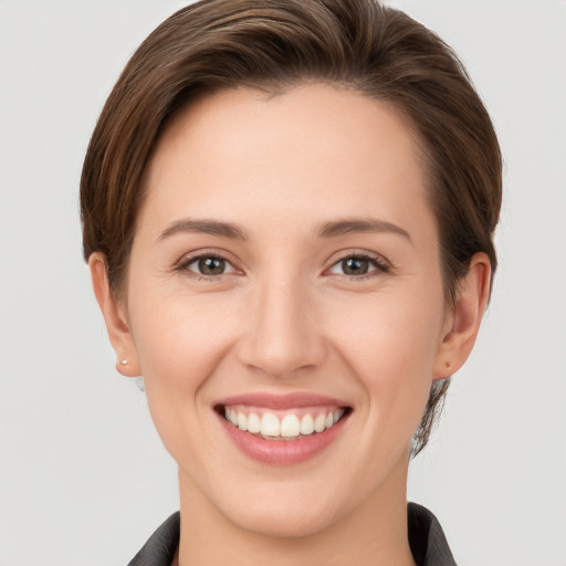 Joyful white young-adult female with short  brown hair and grey eyes