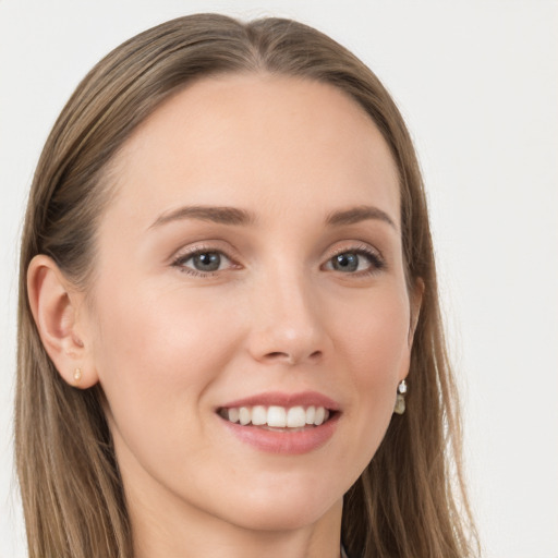 Joyful white young-adult female with long  brown hair and grey eyes