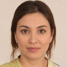 Joyful white young-adult female with medium  brown hair and brown eyes