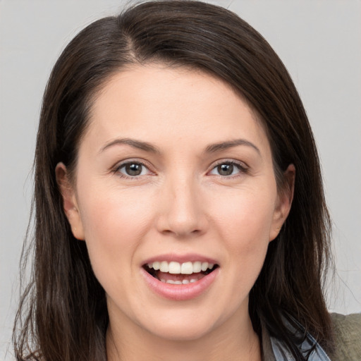 Joyful white young-adult female with long  brown hair and brown eyes