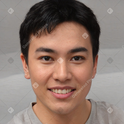 Joyful asian young-adult male with short  brown hair and brown eyes