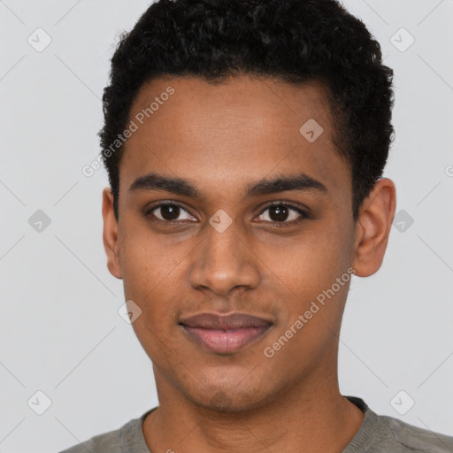 Joyful black young-adult male with short  black hair and brown eyes