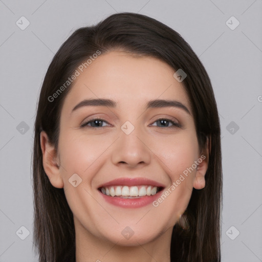 Joyful white young-adult female with long  brown hair and brown eyes