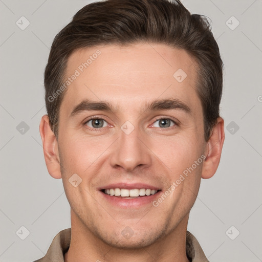 Joyful white young-adult male with short  brown hair and grey eyes