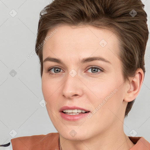 Joyful white young-adult female with short  brown hair and grey eyes