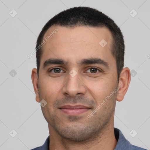 Joyful white young-adult male with short  black hair and brown eyes