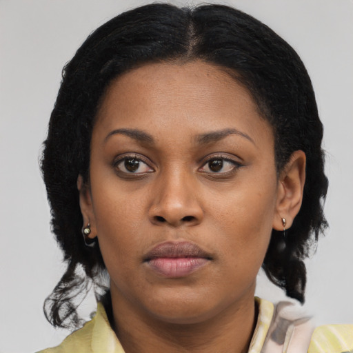 Neutral black young-adult female with medium  brown hair and brown eyes
