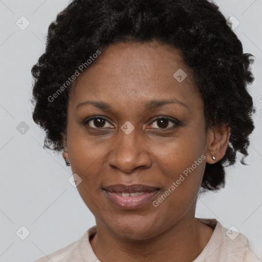 Joyful black adult female with short  brown hair and brown eyes