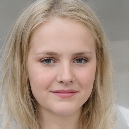 Joyful white young-adult female with medium  brown hair and blue eyes