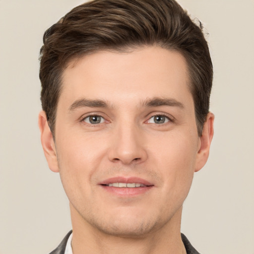 Joyful white young-adult male with short  brown hair and brown eyes