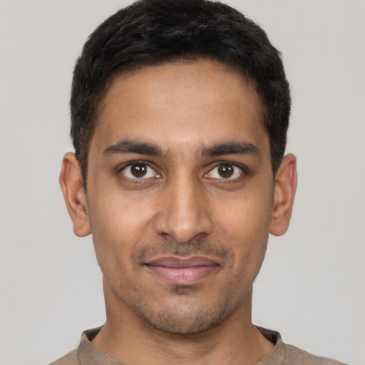 Joyful latino young-adult male with short  brown hair and brown eyes