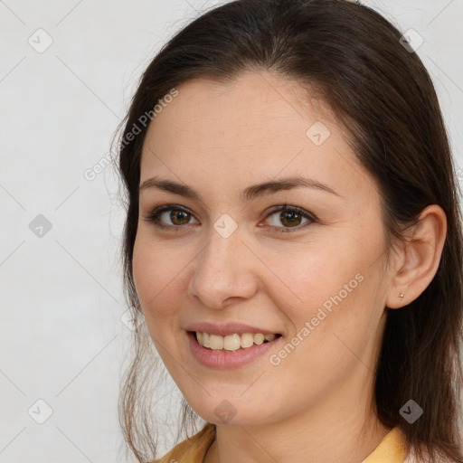 Joyful white young-adult female with long  brown hair and brown eyes