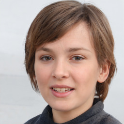 Joyful white child female with medium  brown hair and grey eyes