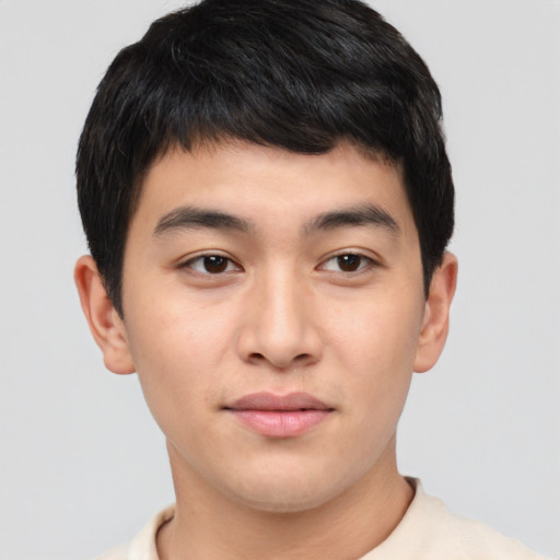 Joyful asian young-adult male with short  black hair and brown eyes