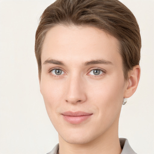 Joyful white young-adult female with short  brown hair and grey eyes