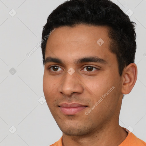 Joyful latino young-adult male with short  black hair and brown eyes