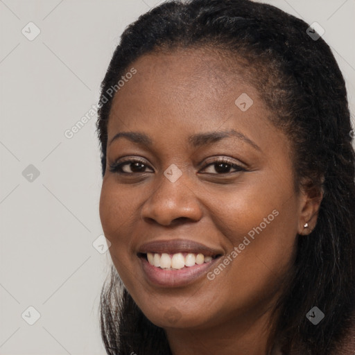 Joyful black young-adult female with long  black hair and brown eyes