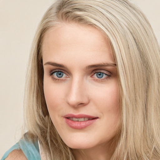 Joyful white young-adult female with long  brown hair and blue eyes