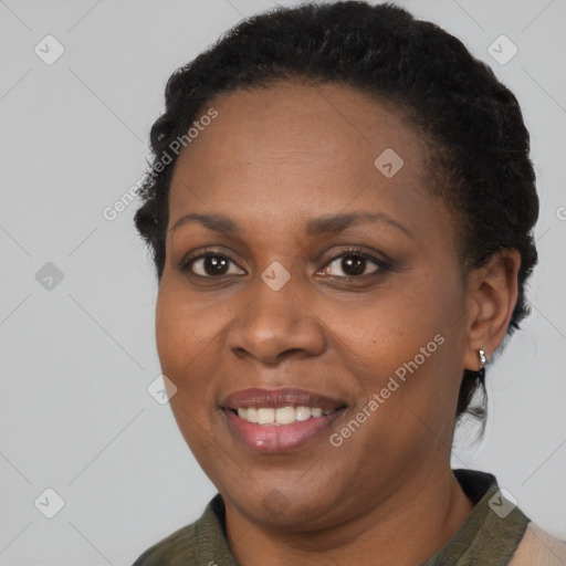 Joyful black adult female with short  brown hair and brown eyes