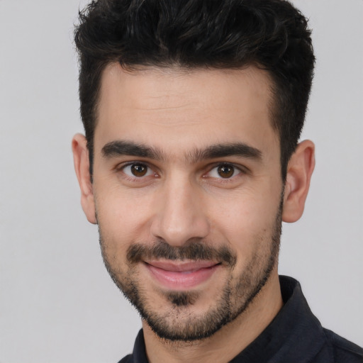 Joyful white young-adult male with short  black hair and brown eyes