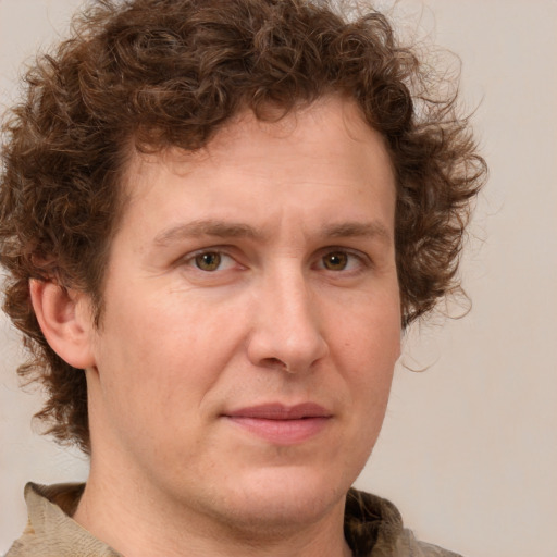 Joyful white adult male with medium  brown hair and brown eyes