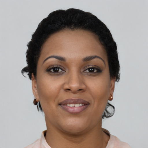 Joyful latino young-adult female with short  brown hair and brown eyes
