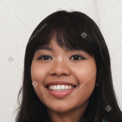 Joyful latino young-adult female with long  black hair and brown eyes