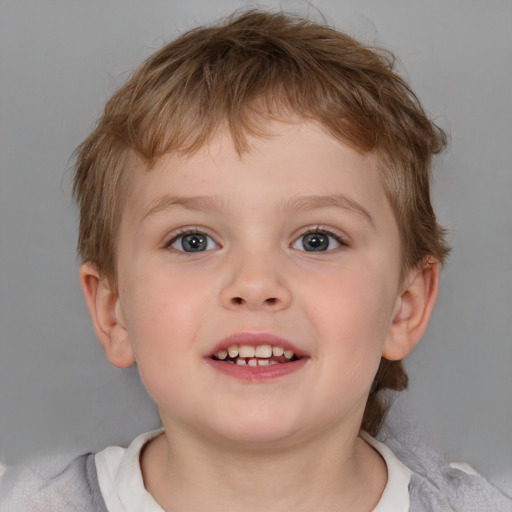 Joyful white child male with short  brown hair and blue eyes