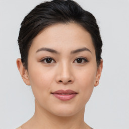 Joyful asian young-adult female with short  brown hair and brown eyes