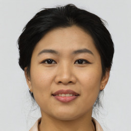 Joyful asian young-adult female with medium  brown hair and brown eyes